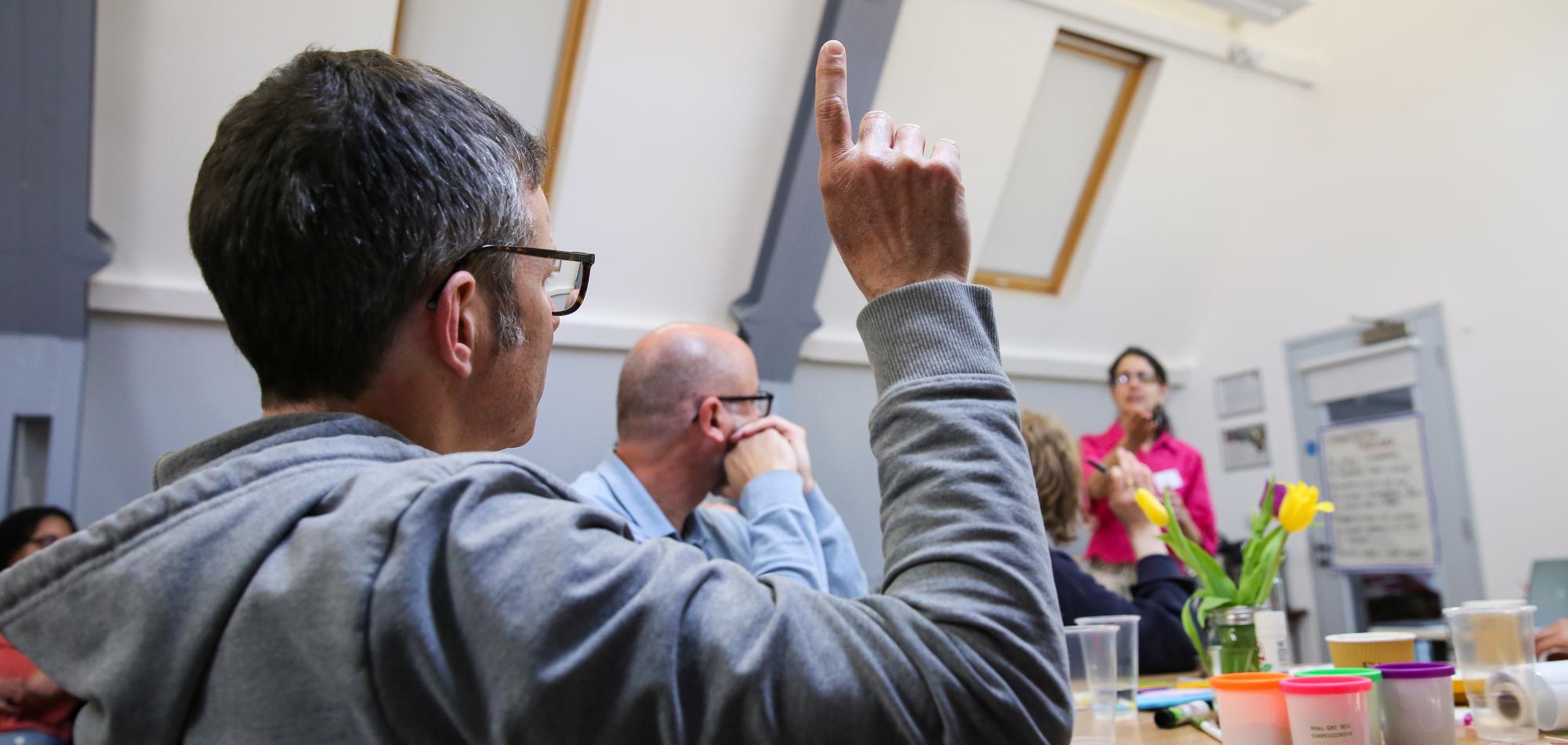 A person raising their hand