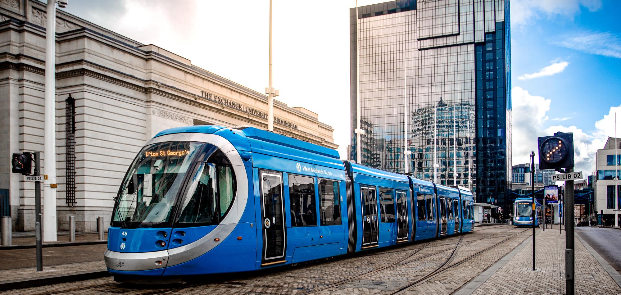 A blue tram in the centre of Birmingham