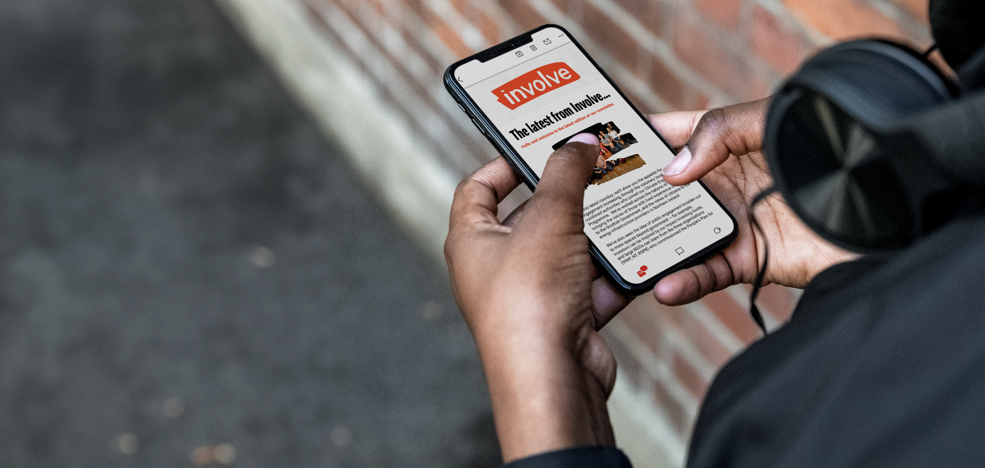 Person reading an Involve newsletter on their phone