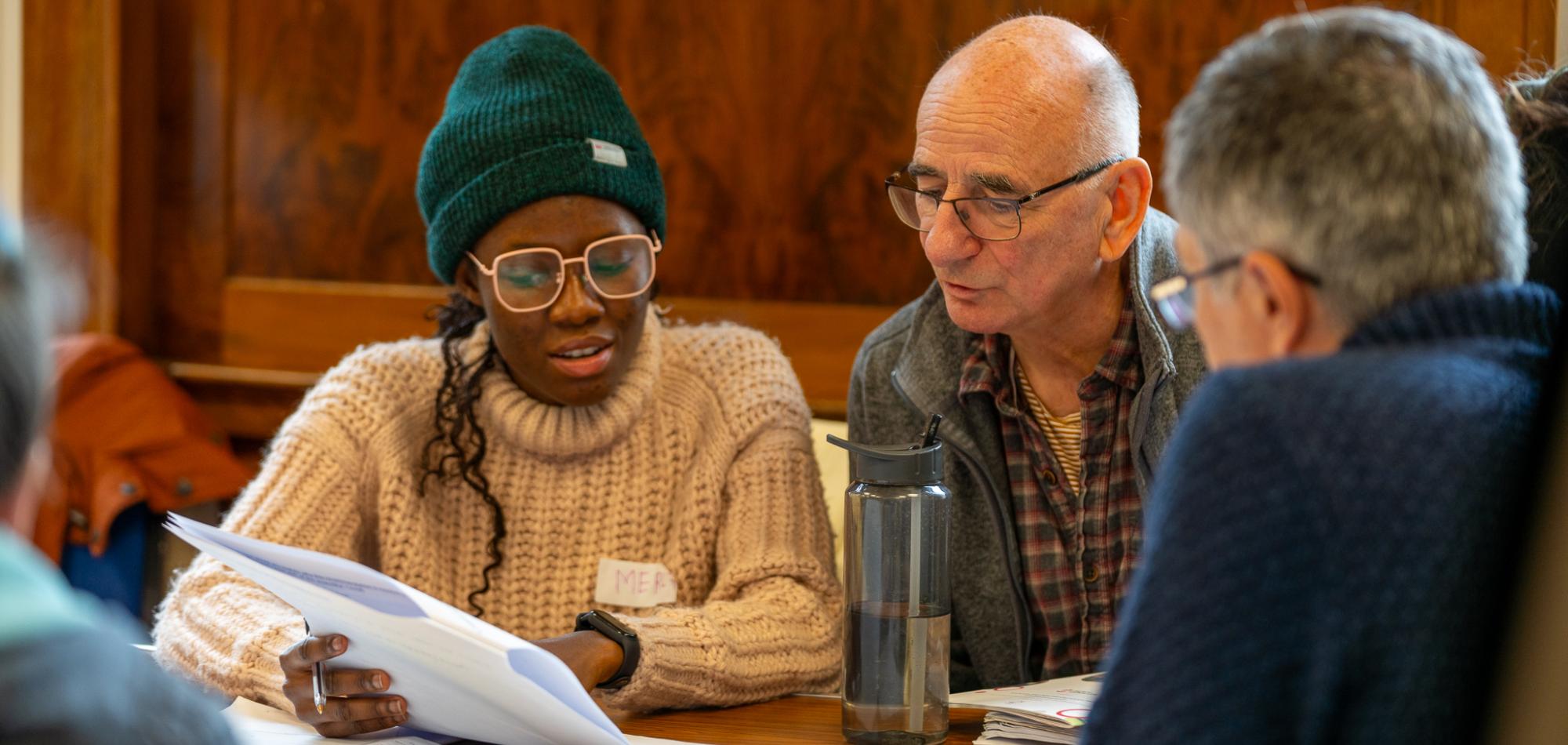 Citizens' assembly members look at a document together