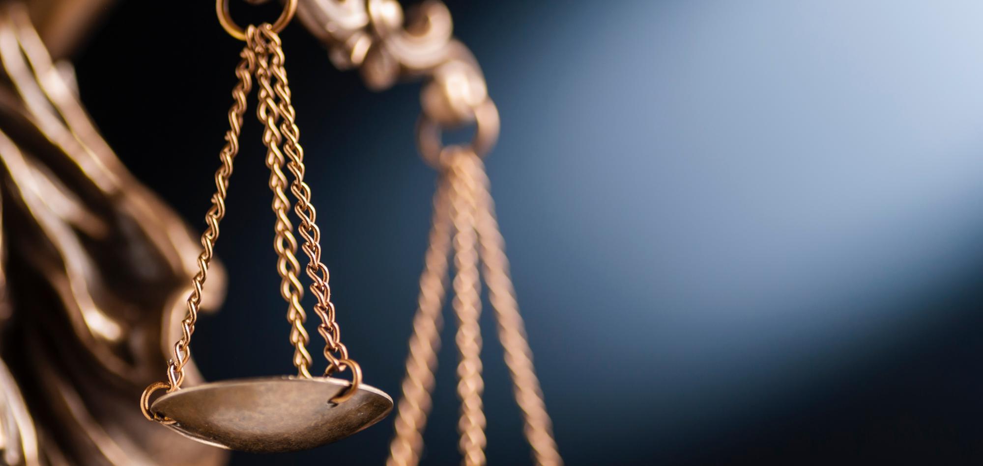 Close up shot of the scales of justice