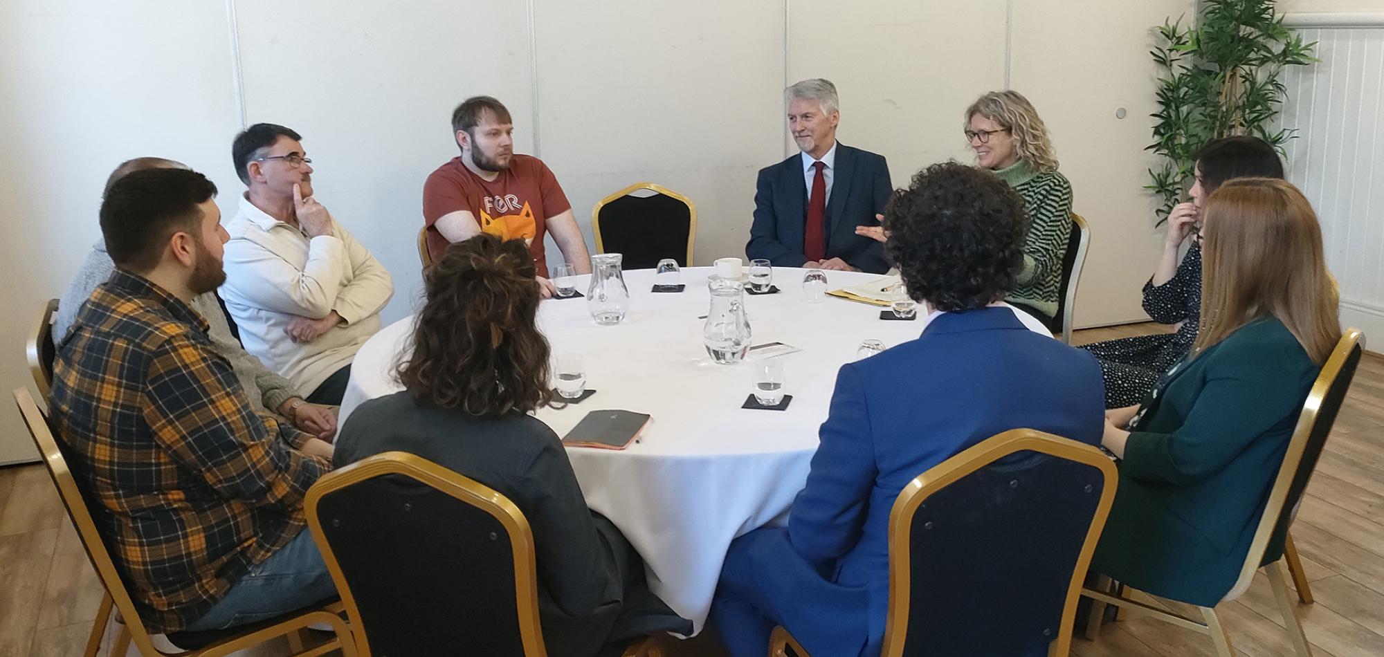 Participants from Future of Travel Citizens Forum in Blaenau Gwent sat around a round table with Deputy First Minister of Wales, Huw Irranca-Davies.