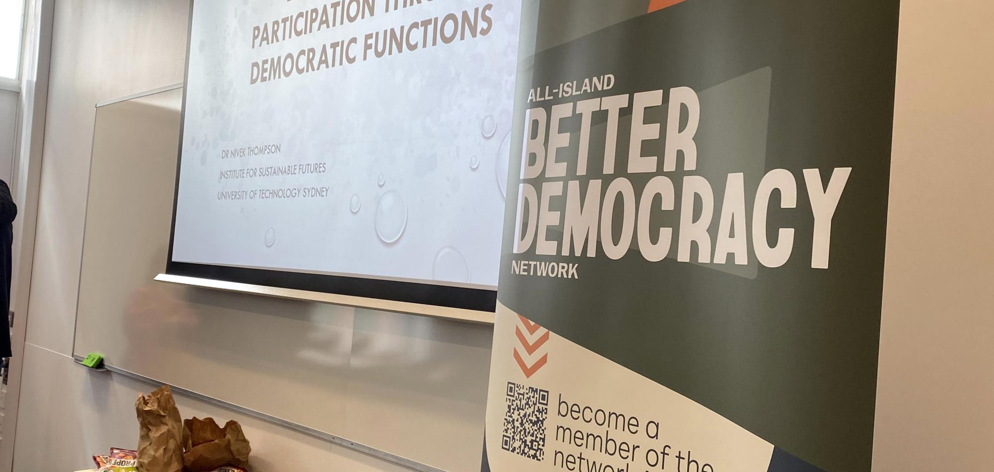 A banner and projector screen.