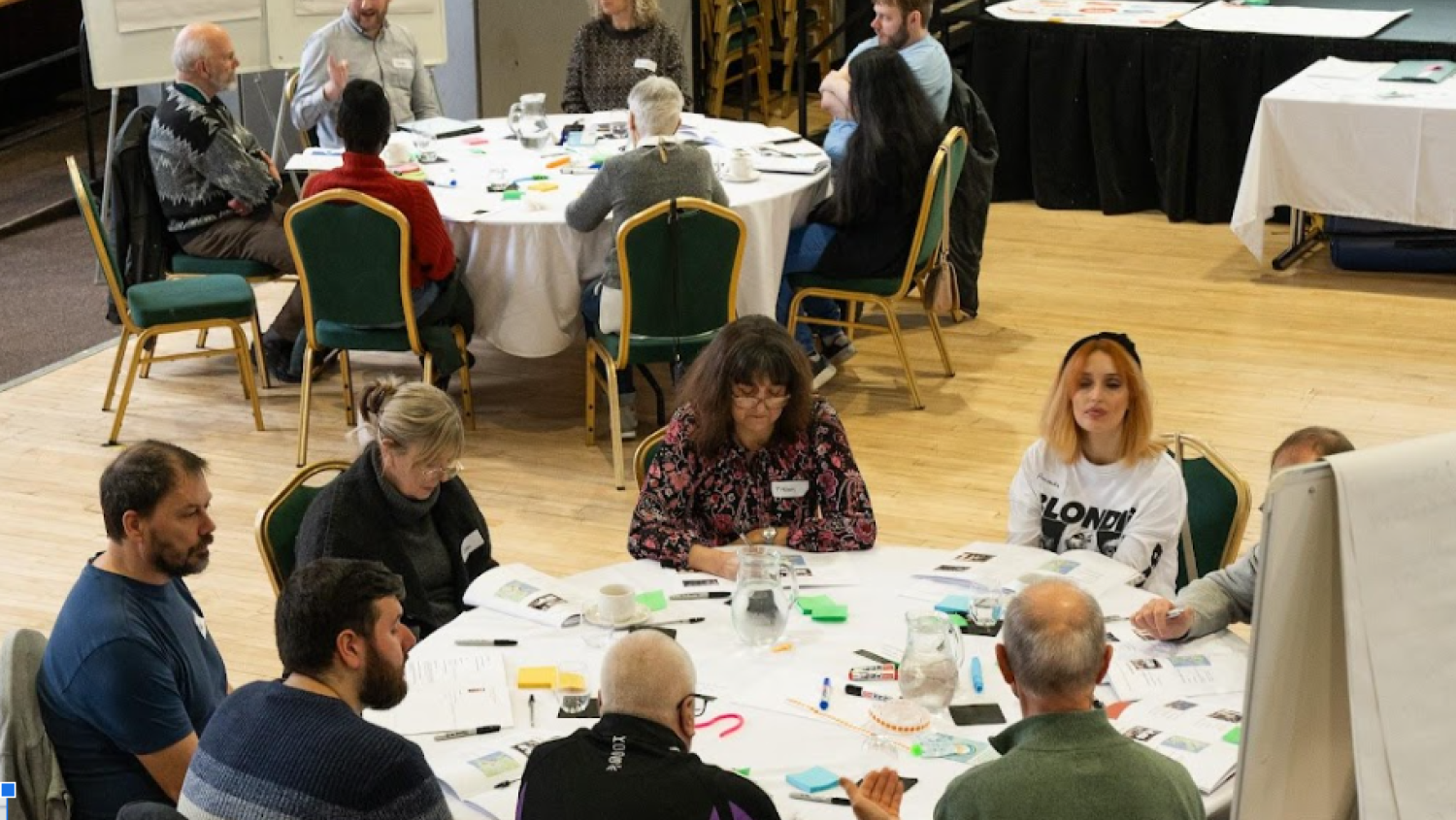 Picture of people in a room chatting about ideas.
