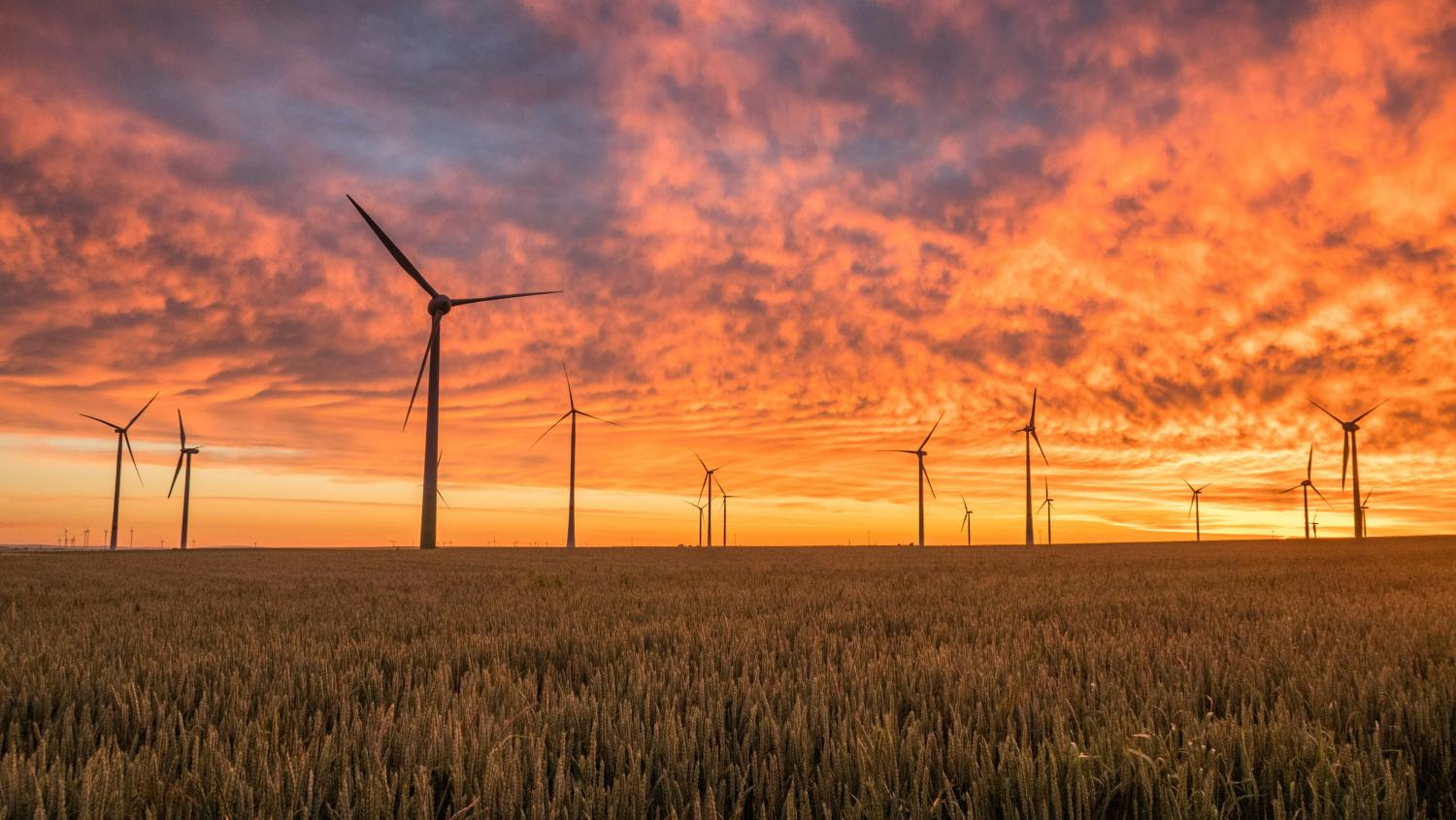 Sunset sky with wind turbnines 