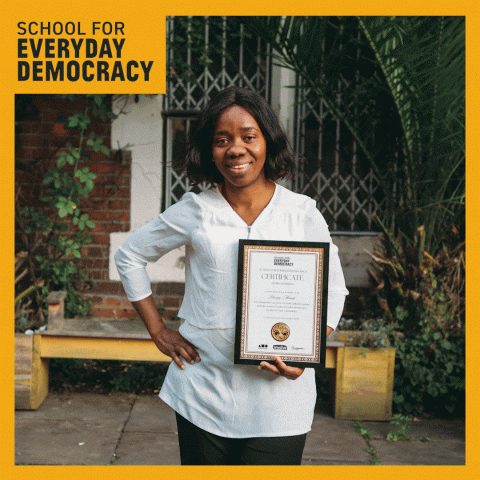 School for everday democracy graduates posing with their certificates