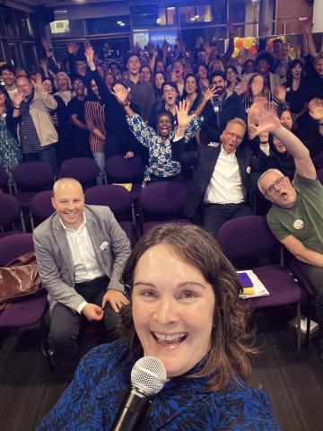 Sarah Castell takes a selfie with attendees